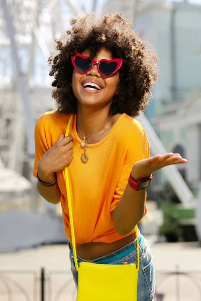 Charmiga lockigt kvinna i hjärtformade solglasögon utstrålar lycka — Stockfoto