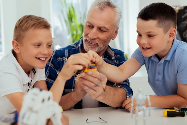 Cheerful happy boys touching the microscheme — Stock Photo, Image