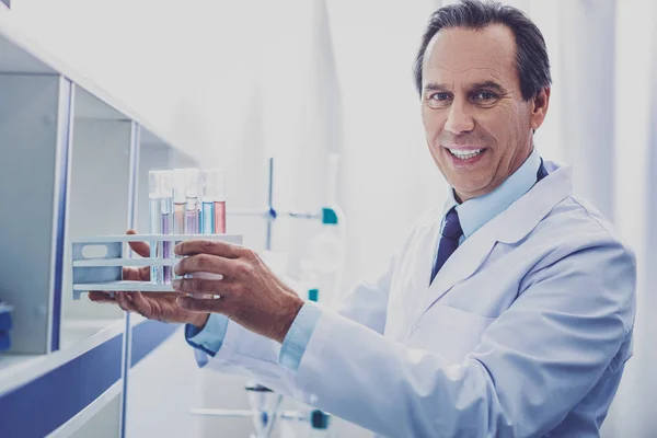 Experienced chemist putting test tubes in order — Stock Photo, Image