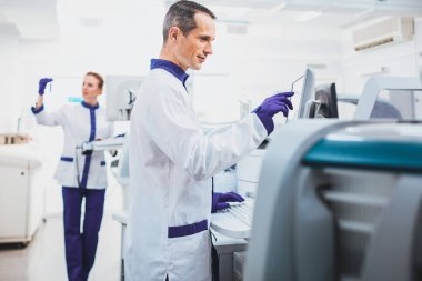 Bilgisayar ekranına bakarak ciddi laboratuar asistanı