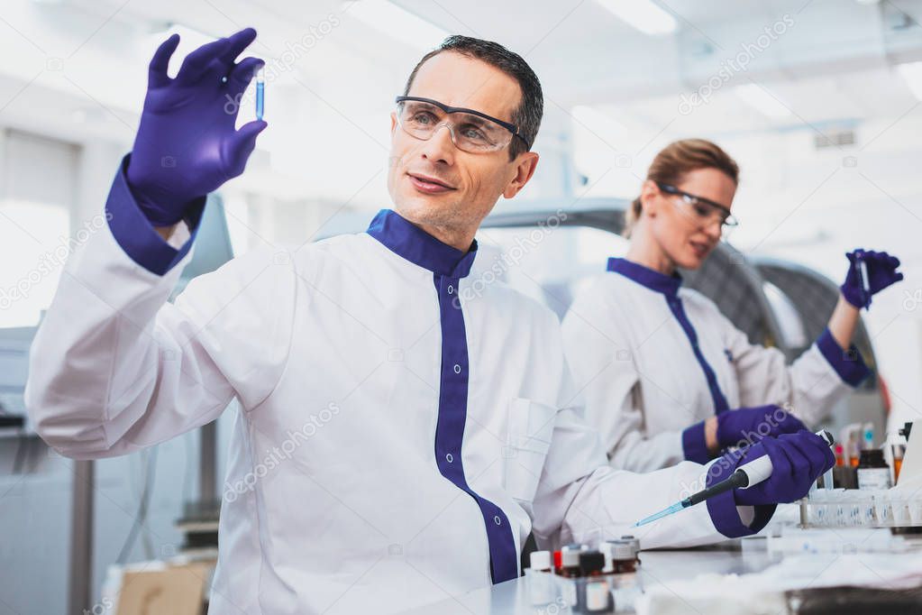 Cheerful male person working in laboratory