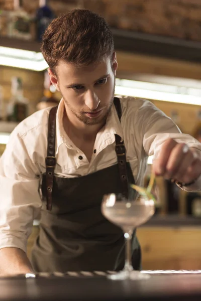 Junger professioneller Barmann schmückt seinen Cocktail — Stockfoto
