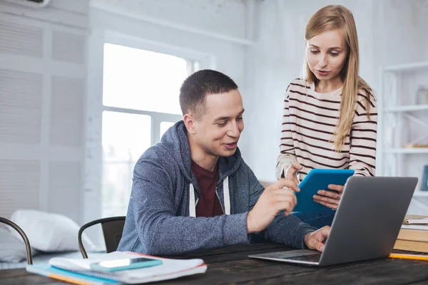 Joyful girl showing photos to her boyfriend — Stock Photo, Image