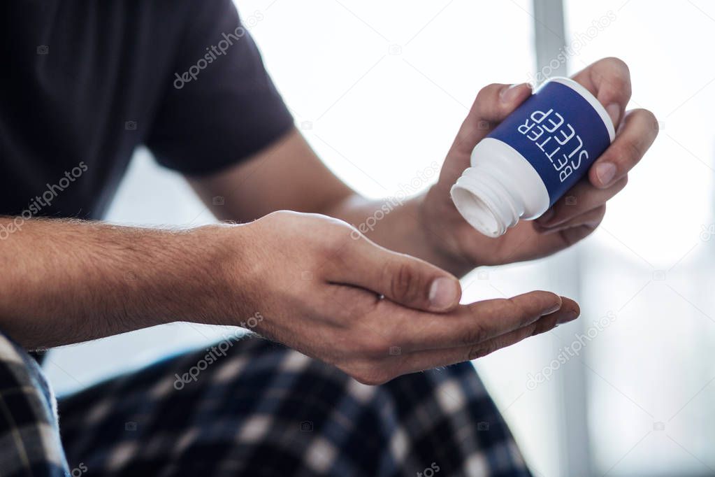 Tired man holding an effective medication