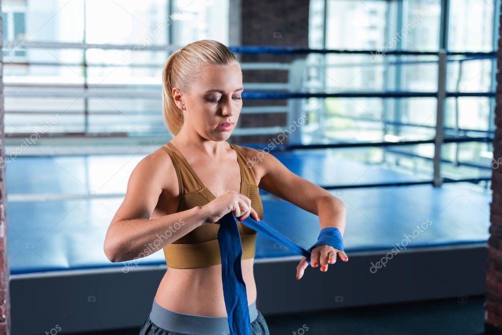 Blonde-haired female athlete wearing sport bra