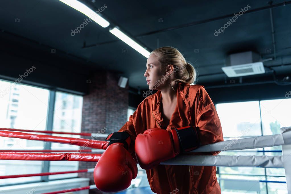 Female boxer wearing red baggy sport jacket
