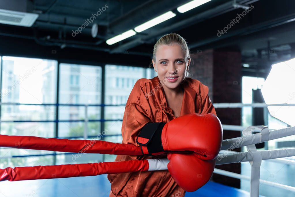 Beautiful businesswoman enjoying her hobby while boxing in ring