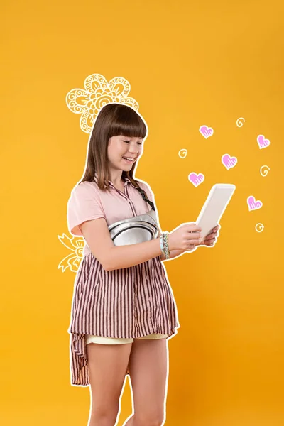 Positive girl feeling happy while using a new tablet — Stock Photo, Image