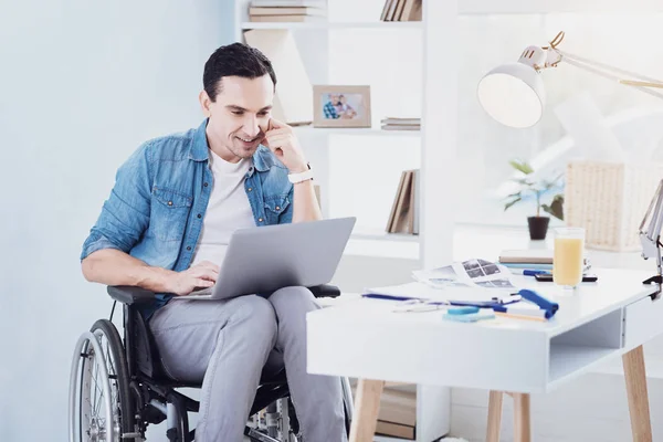 Enigmatical brunette male staring at his laptop — Stock Photo, Image