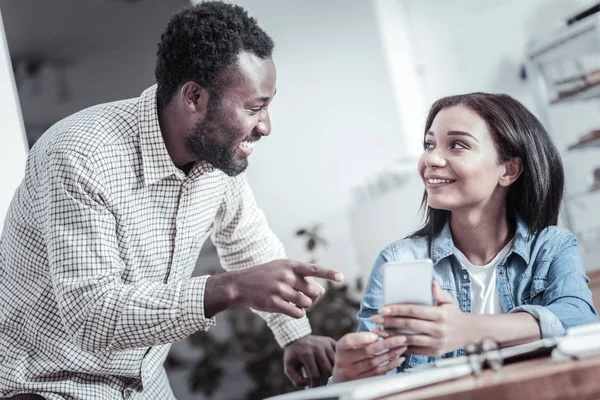 Delighted positive man pointing at the screen