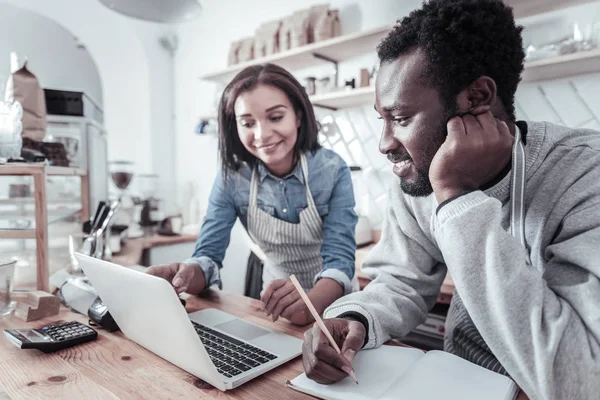 Positive smart man taking notes — Stock Photo, Image