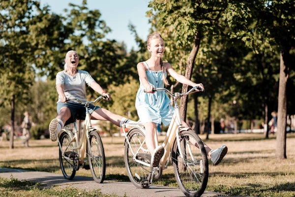 Positive delighted girl raising both legs — Stock Photo, Image