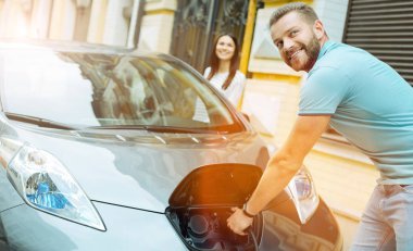 Seyahat ederken bir elektrikli araba şarj genç şirin çift