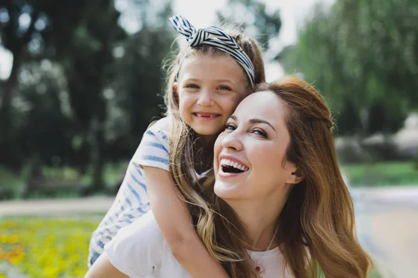 Cute beaming daughter spending time with her mother — Stock Photo, Image