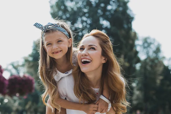 Beautiful mother and daughter having nice walk in the park — Stock Photo, Image