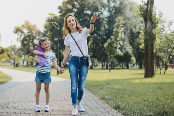 Beautiful mother taking her birthday girl to the park — Stock Photo, Image