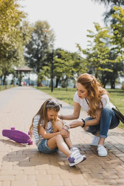 Mother feeling anxious while seeing her daughter falling