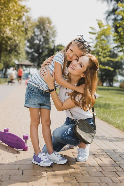 Caring young mother hugging her little girl — Stock Photo, Image