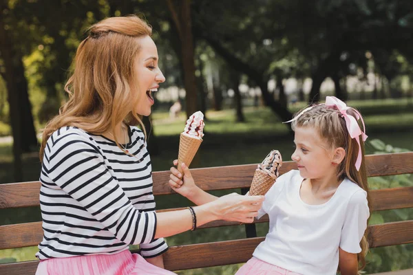 Modern mother having fun with her child eating ice cream — Stock Photo, Image