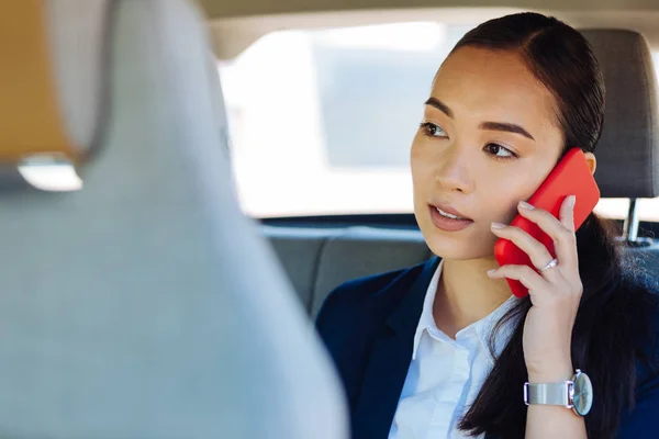 Smart young woman having a phone conversation