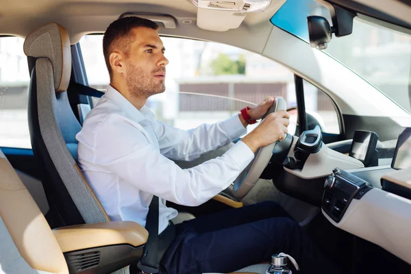 Careful male driver looking into the mirror — Stock Photo, Image