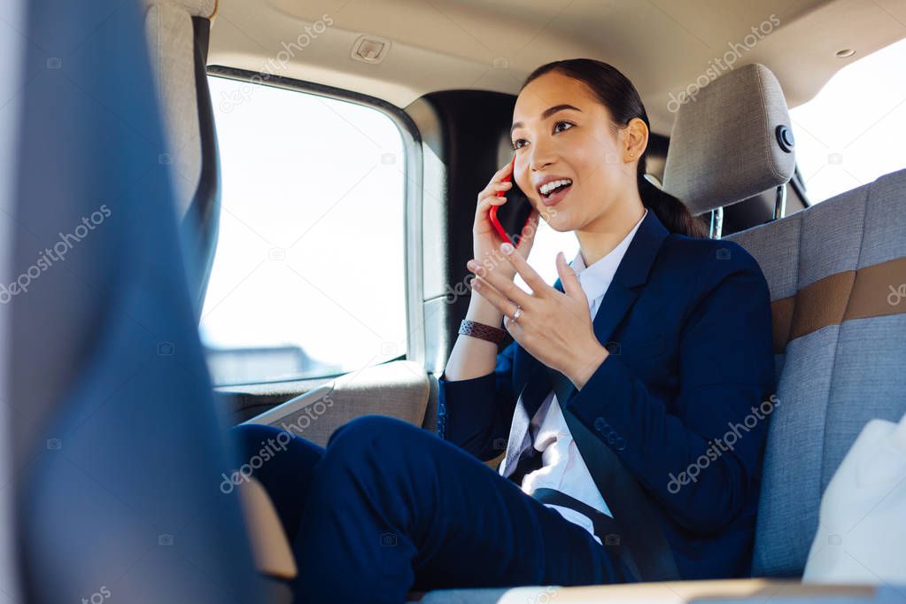 Delighted nice woman discussing work