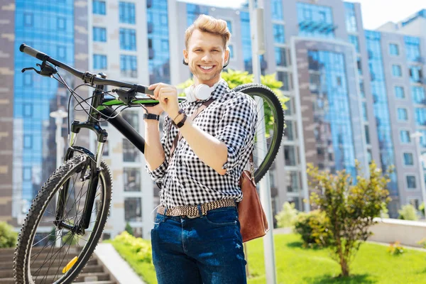 Pozytywny człowiek silny, trzymając jego rower — Zdjęcie stockowe