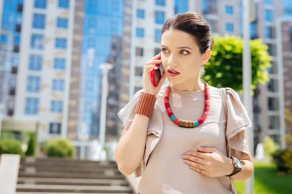 Angenehme junge Frau hört ihrem Gesprächspartner zu — Stockfoto