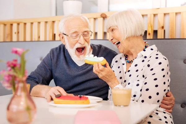 Happy senior woman entertaining husband — Stock Photo, Image