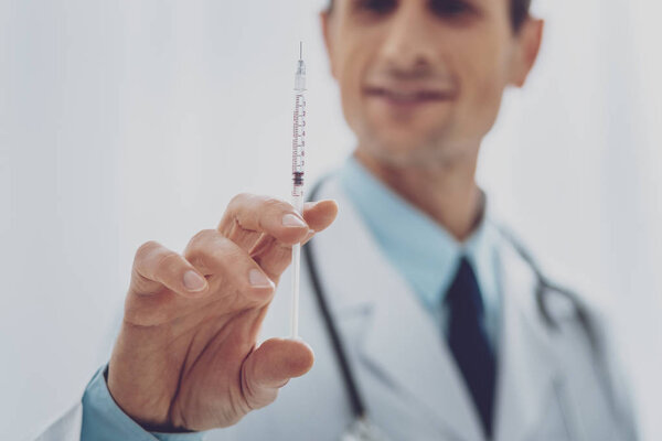 Close up of male hand that holding syringe