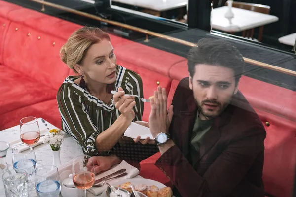 Focused mature woman proposing food — Stock Photo, Image