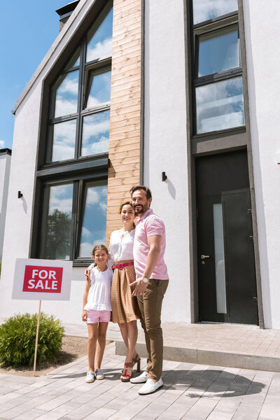 Joyful positive family buying a house