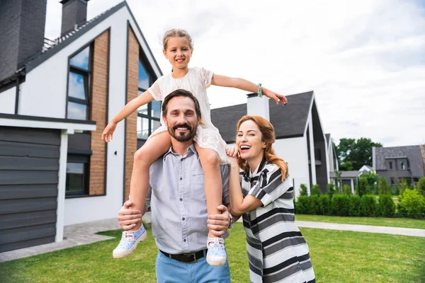 stock image Pleasant handsome man holding his daughter