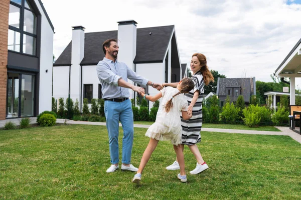 stock image Joyful positive family holding hands