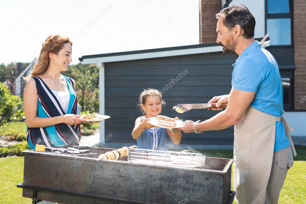 Nice exited girl taking food