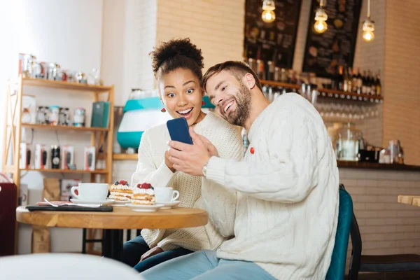 Blonde-haired bearded man leaning on his beautiful girlfriend