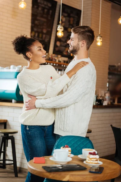 Dark-haired curly woman hugging her lovely boyfriend — Stock Photo, Image