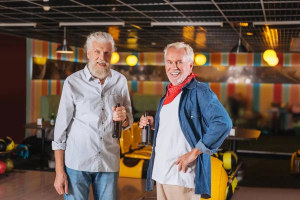 正面微笑的老男人站在一起在保龄球俱乐部 — 图库照片