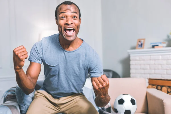 Obsessed football fan watching a match — Stock Photo, Image