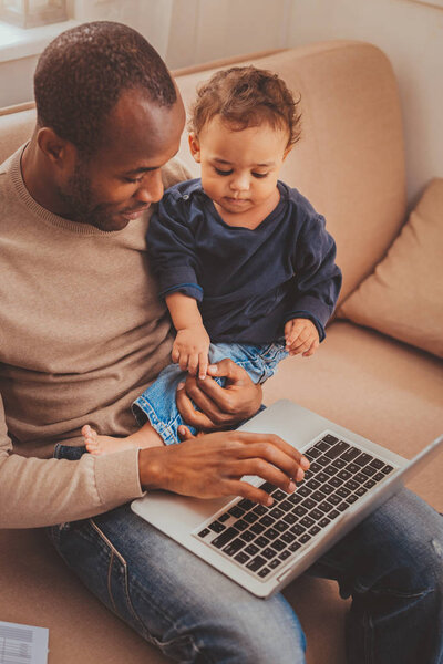 Cheerful father working with his son