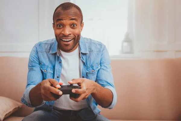 Cheerful young man playing games — Stock Photo, Image