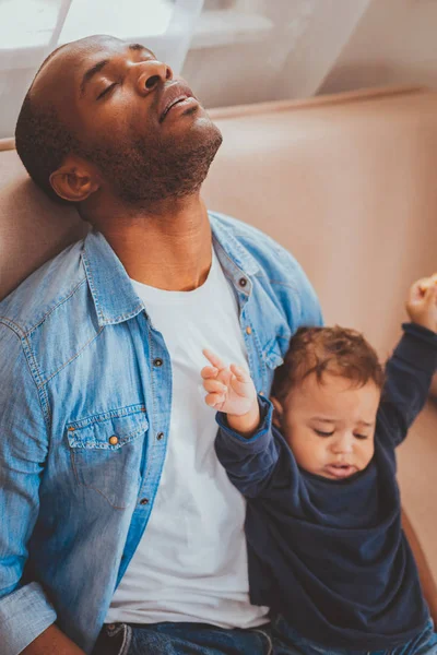 Padre agotado cuidando a su hijo y durmiendo —  Fotos de Stock