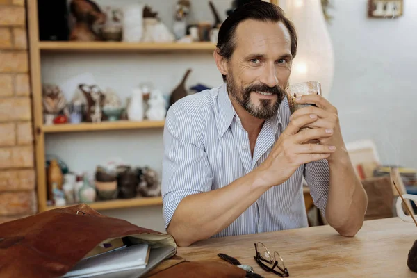 Good-looking mature man smiling while feeling inspired — Stock Photo, Image