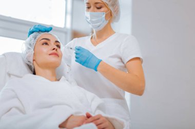 Üzerinde yaptığı çalışmalar odaklanarak ciddi güzel kadın güzellik uzmanı