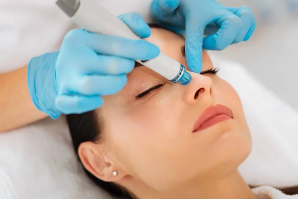 Face of a nice good looking woman during hydrafacial — Stock Photo, Image