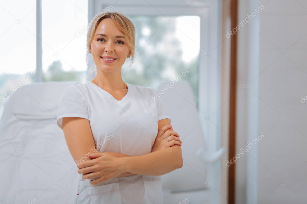 Joyful happy young woman standing cross handed