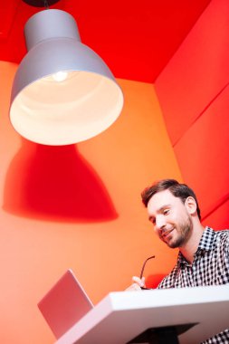 Ekrana bakarak ve iyi duygu neşeli genç programcı