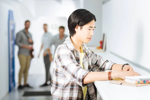 Concentrated student doing homework while being in coworking space — Stock Photo, Image