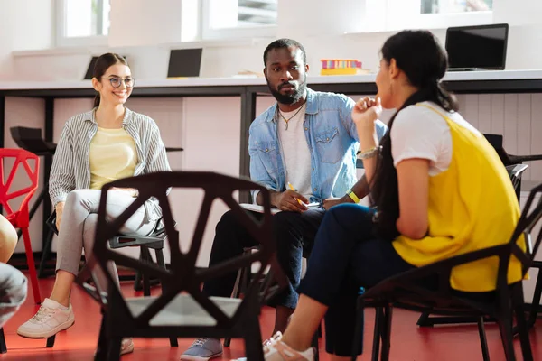 Think Nervous Young Man Looking Friendly Young Girls While Sitting — Stock Photo, Image