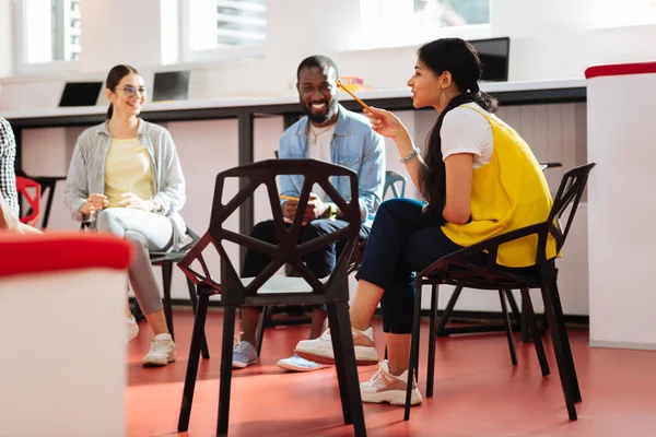 Group of friendly people sitting in circle and having a pleasant talk — Stock Photo, Image